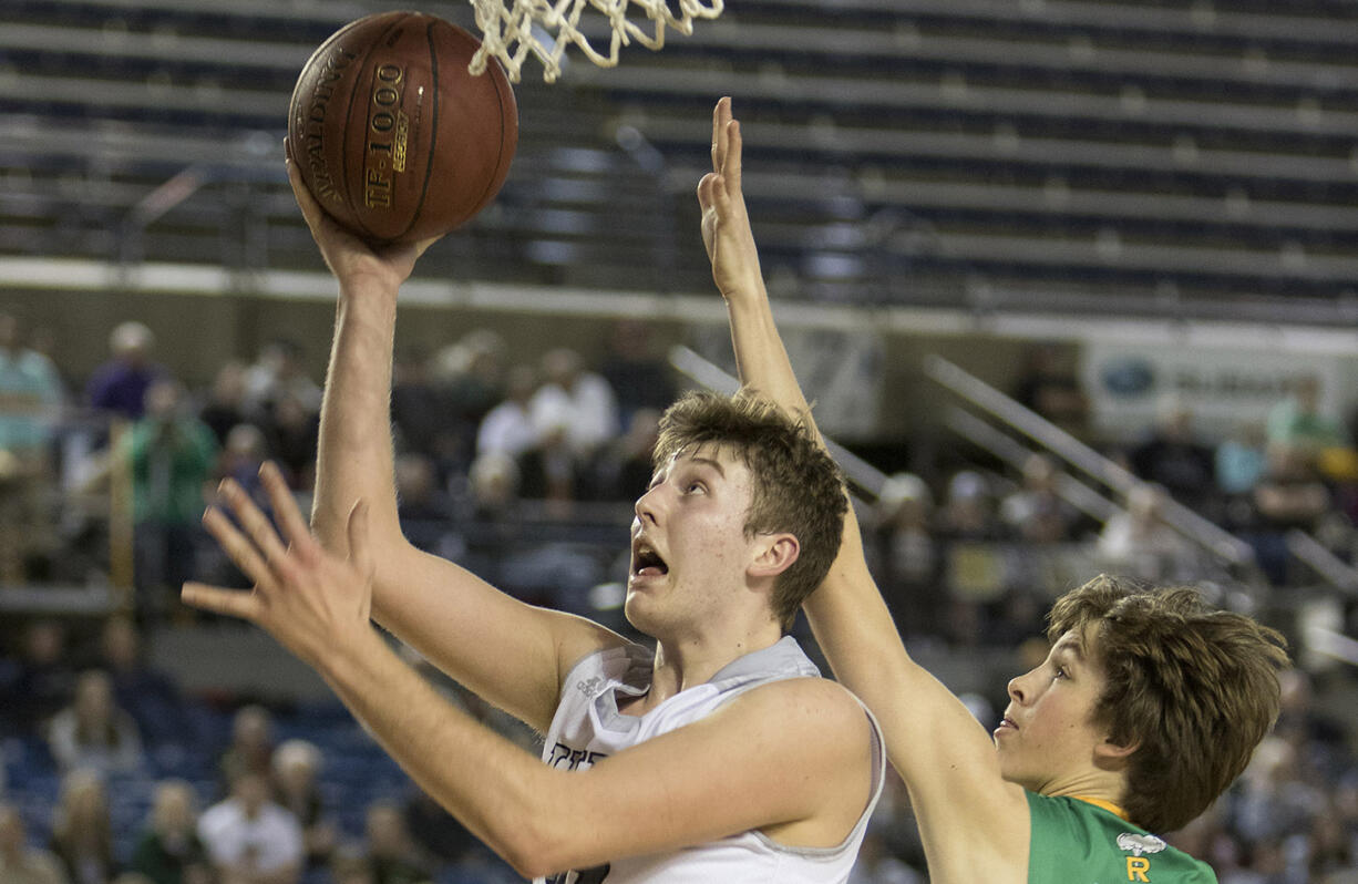 Union's Cameron Cranston gets past Richland's Garrett Streufert for a lay up Friday, March 3, 2017, during the semi-finals of the 4A Boys State Basketball Tournament in Tacoma, Wash. Cranston had a game-high 25 points. Union defeated Richland 63-61 to advance to the championship game.