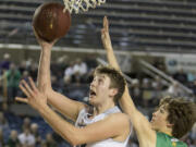 Union's Cameron Cranston gets past Richland's Garrett Streufert for a lay up Friday, March 3, 2017, during the semi-finals of the 4A Boys State Basketball Tournament in Tacoma, Wash. Cranston had a game-high 25 points. Union defeated Richland 63-61 to advance to the championship game.