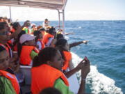 Students from the St. Rose Institute for Deaf Assistance spot whales during a tour off Samana, Dominican Republic in March.