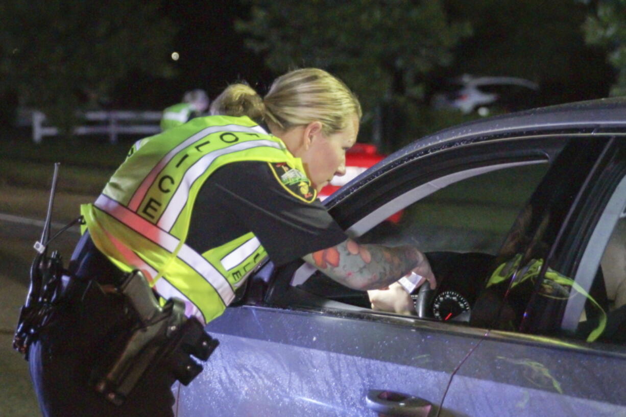 Officer Teresa Orr with the Jacksonville Police Department speaks with a driver May 20 at a checkpoint in Jacksonville, N.C.