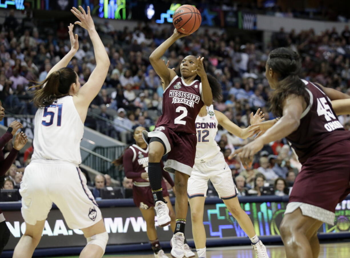 Mississippi State guard Morgan William (2) drives to the basket as Connecticut center Natalie Butler (51) defends during the first half of an NCAA college basketball game in the semifinals of the women&#039;s Final Four, Friday, March 31, 2017, Friday, March 31, 2017, in Dallas.