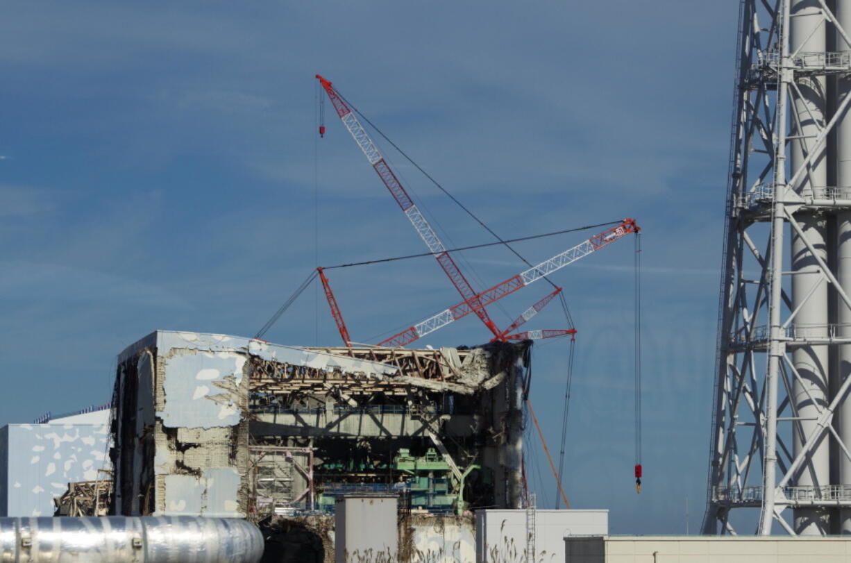 The Unit 4 reactor building of the crippled Fukushima Dai-ichi nuclear power station is seen through a bus window in Okuma, Japan, Nov. 12, 2011. Research scientist John Smith, who works for Canada&#039;s fisheries and oceans department, told The Associated Press Thursday, that &#039;crazy low levels&#039; of cesium from Fukushima found in a Canadian salmon are no cause for alarm.