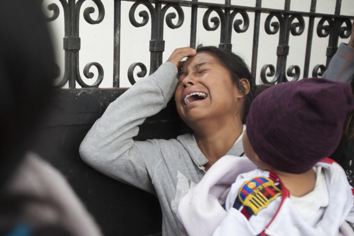 A relative of a youth who resided at the Virgin of the Assumption Safe Home cries as she waits for the release of the names of those who died in the fire Thursday outside the morgue in Guatemala City, where the bodies are being identified.