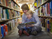 Jess Wood reads &quot;The Little Engine that Could&quot; to her daughter, Wynn Wood, 2, at the Eugene Public Library in Eugene., Ore.