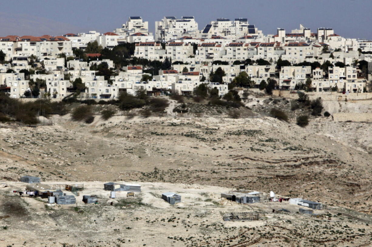 The Israeli settlement of Maaleh Adumim, shown in January, looms over Arab Bedouin shacks in the West Bank.