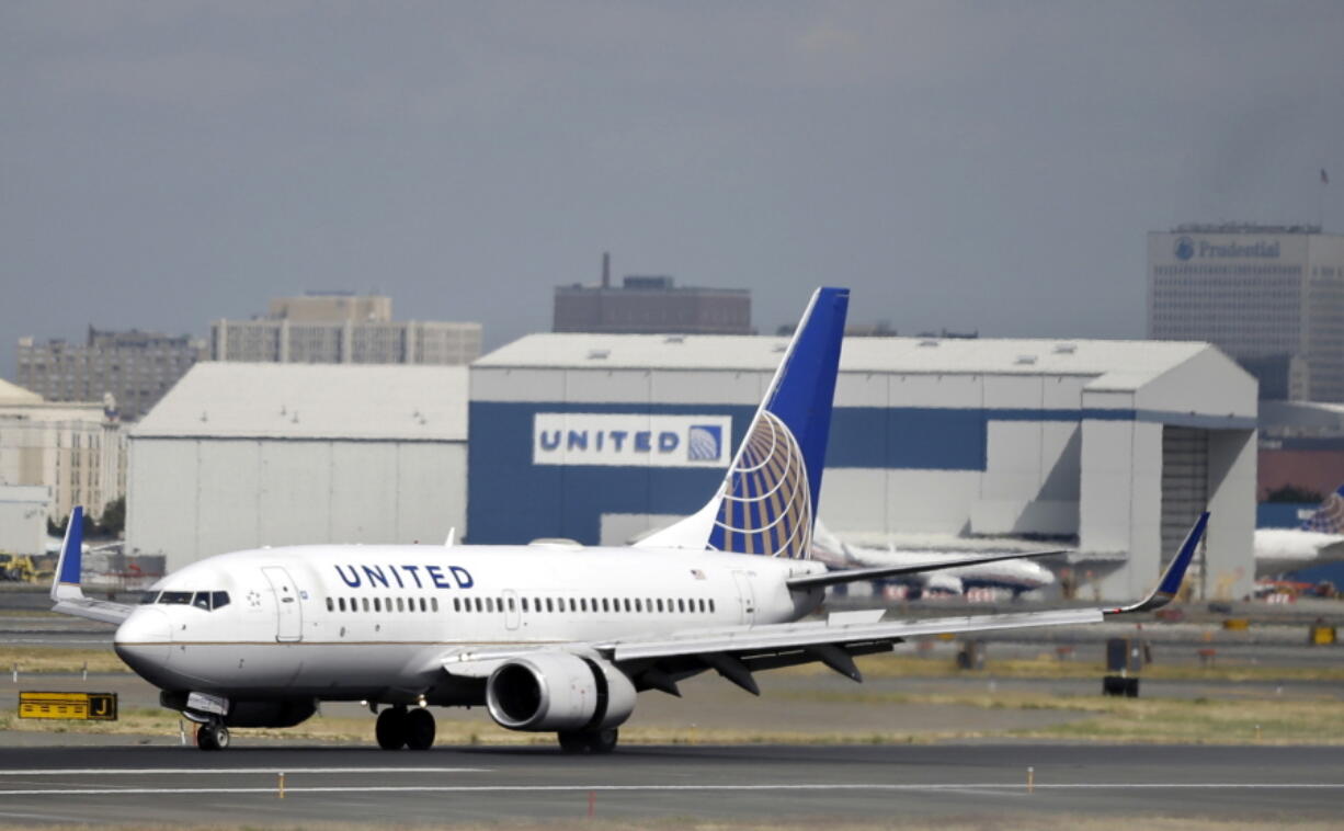 A United Airlines passenger plane lands at Newark Liberty International Airport in Newark, N.J.