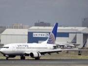 A United Airlines passenger plane lands at Newark Liberty International Airport in Newark, N.J.