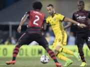 Columbus Crew forward Justin Meram advances the ball past Portland Timbers defender Alvas Powell during the first half of an MLS soccer match, Saturday, March 25, 2017, in Columbus, Ohio.