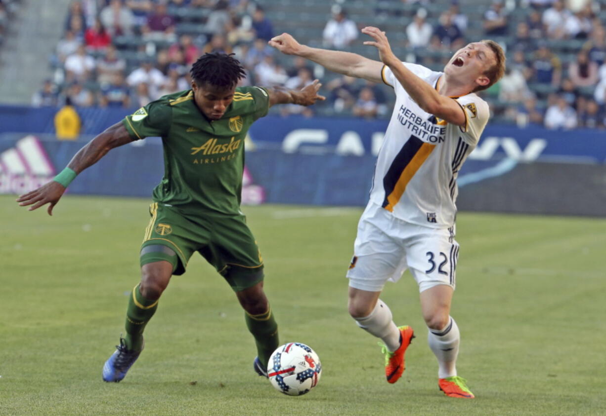 LA Galaxy forward Jack McBean (32) wants a call but none is forthcoming after taking a hand to the face from Portland Timbers defender Alvas Powell (2) during the second half of an MLS soccer match in Carson, Calif., Sunday, March 12, 2017. The Timbers won 1-0.