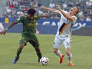 LA Galaxy forward Jack McBean (32) wants a call but none is forthcoming after taking a hand to the face from Portland Timbers defender Alvas Powell (2) during the second half of an MLS soccer match in Carson, Calif., Sunday, March 12, 2017. The Timbers won 1-0.