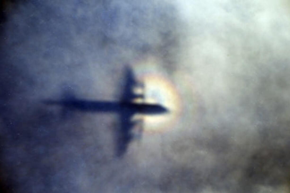 The shadow of a Royal New Zealand Air Force plane is seen on low-level clouds while the aircraft searches for missing Malaysia Airlines Flight MH370 in the Indian Ocean in March 2014.