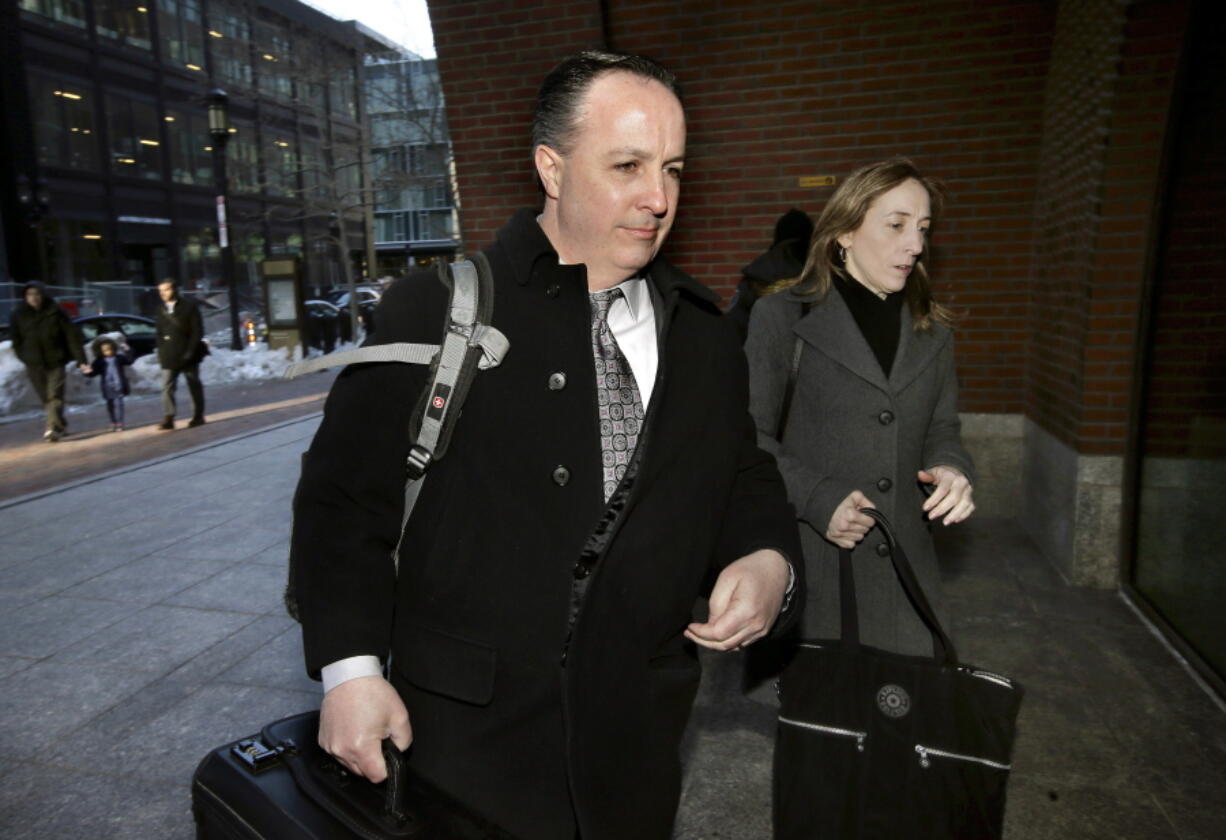 Barry Cadden, center, arrives at the federal courthouse Thursday in Boston, before scheduled closing arguments in his trial. Cadden, a former pharmacy executive and the president of New England Compounding Center, is charged with causing the deaths in 2012 of 25 people who received tainted steroids manufactured by the pharmacy.