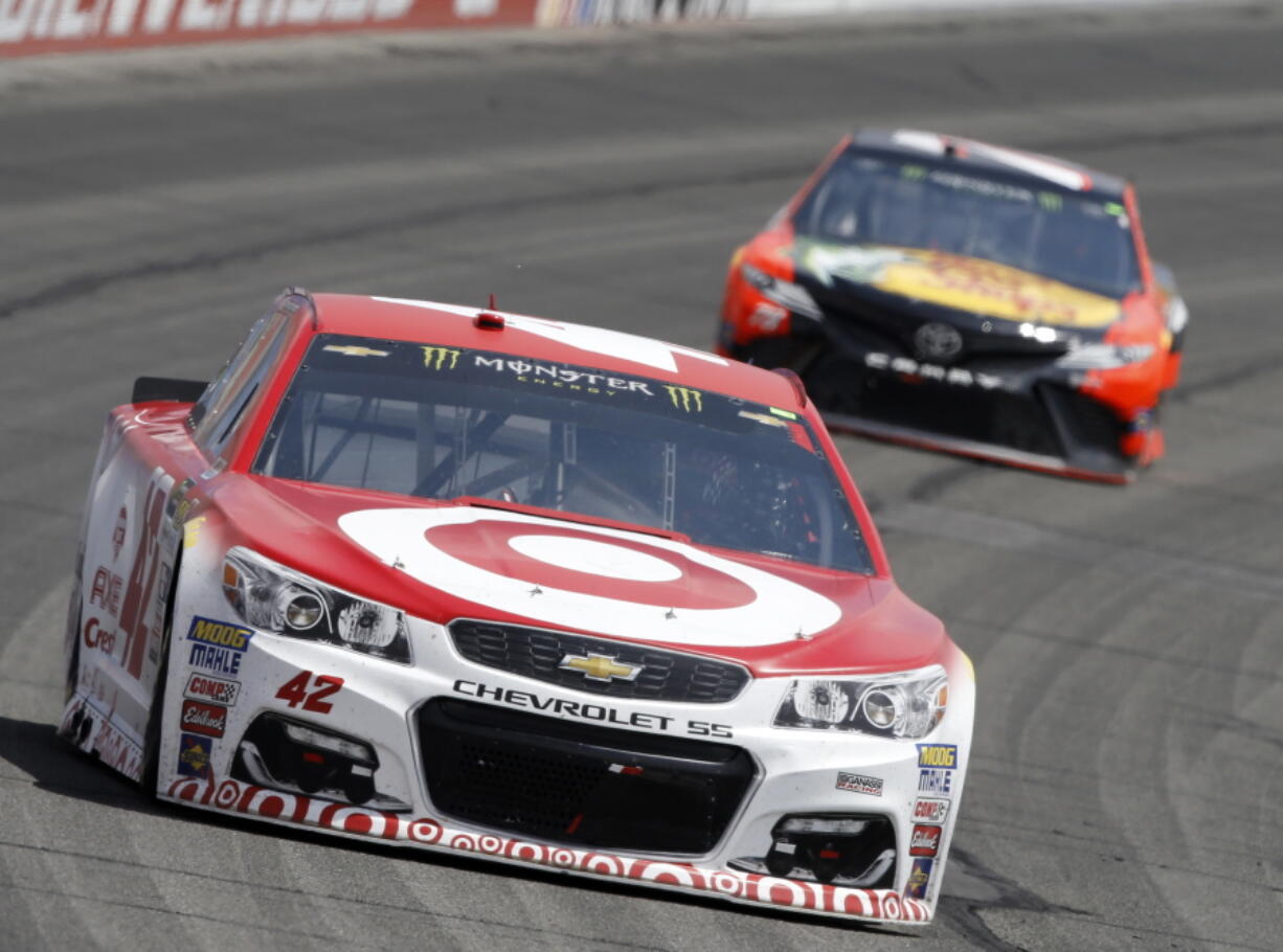 Kyle Larson, left, leads Martin Truex Jr., right, to take the first stage (the first 60 laps) of the NASCAR Cup Series auto race at Auto Club Speedway in Fontana, Calif., Sunday, March 26, 2017.