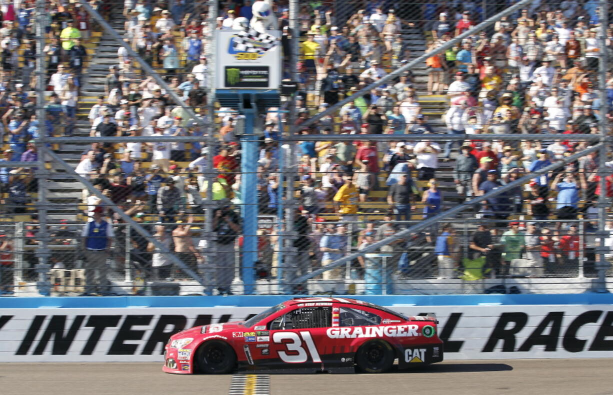 Ryan Newman takes the checkered flag to win the NASCAR Cup Series auto race at Phoenix International Raceway, Sunday, March. 19, 2017, in Avondale, Ariz.