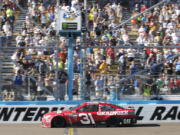 Ryan Newman takes the checkered flag to win the NASCAR Cup Series auto race at Phoenix International Raceway, Sunday, March. 19, 2017, in Avondale, Ariz.