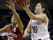 Washington&#039;s Kelsey Plum, right, drives past Oklahoma&#039;s Gioya Carter during the second half of Monday&#039;s NCAA second-round tournament game at Seattle. Plum led all scorers with 38 points as Washington won 108-82.