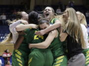 Teammates hug Oregon&#039;s Ruthy Hebard (24) following Hebard&#039;s late shot to give their team a 71-70 win over Temple during a first-round game in the NCAA women&#039;s college basketball tournament in Durham, N.C., Saturday, March 18, 2017.