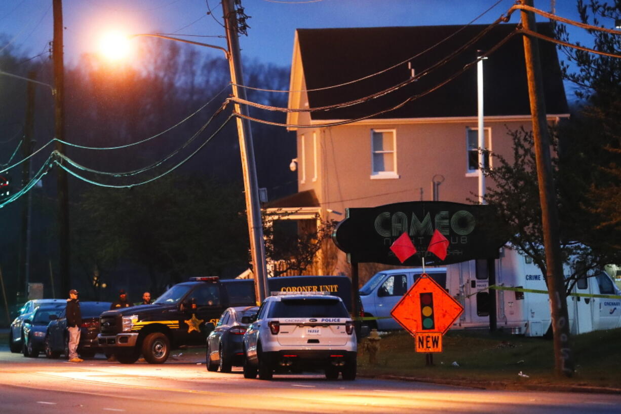 A coroner&#039;s unit pulls away as police operate at a crime scene outside the Cameo club after a fatal shooting, Sunday in Cincinnati.