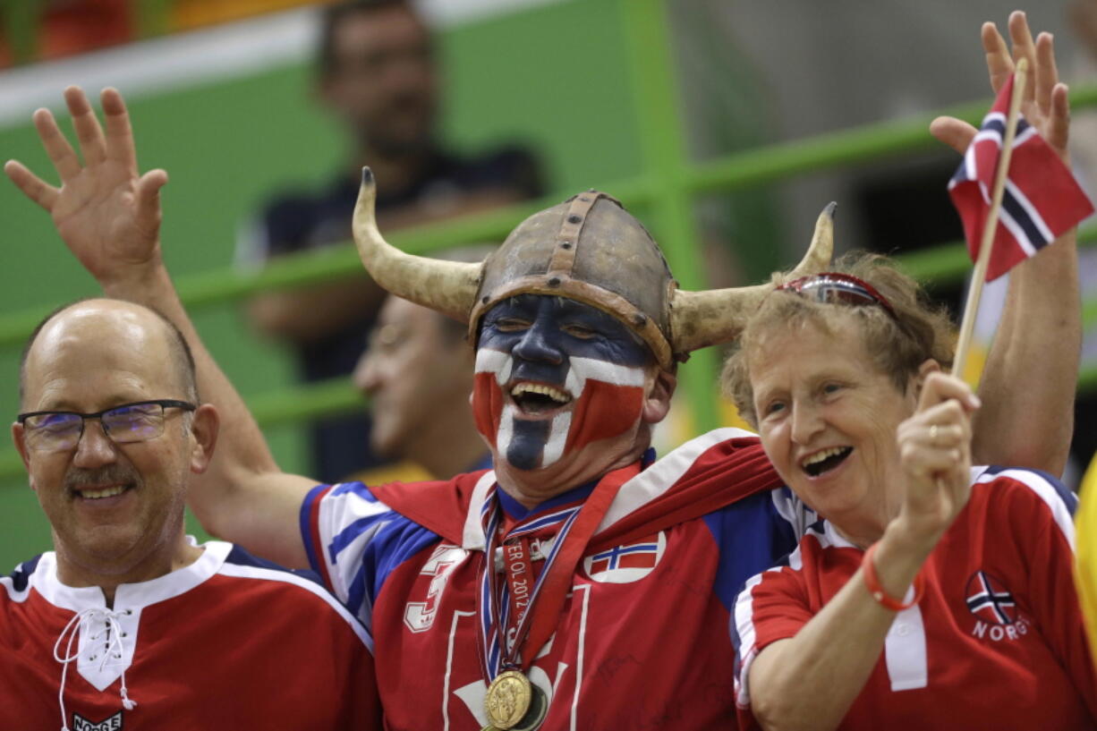 Norwegian fans wait for the beginning of the women&#039;s semifinal handball match between Norway and Russia at the 2016 Summer Olympics Aug. 18 in Rio de Janeiro, Brazil. A global happiness report Monday said that Norway tops the world happiness rankings, edging out Denmark which was No. 1 in the previous report.