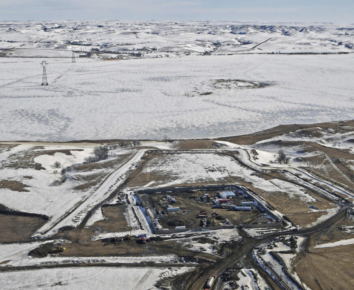 FILE - This Feb. 13, 2017, aerial file photo, shows a site where the final phase of the Dakota Access pipeline is taking place with boring equipment routing the pipeline underground and across Lake Oahe to connect with the existing pipeline in Emmons County near Cannon Ball, N.D. Federal Judge James Boasberg on Tuesday, March 14 denied a request by the Standing Rock and Cheyenne River Sioux to stop oil from flowing while they appeal his earlier decision allowing pipeline construction to finish.