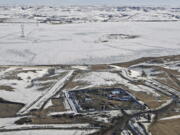 FILE - This Feb. 13, 2017, aerial file photo, shows a site where the final phase of the Dakota Access pipeline is taking place with boring equipment routing the pipeline underground and across Lake Oahe to connect with the existing pipeline in Emmons County near Cannon Ball, N.D. Federal Judge James Boasberg on Tuesday, March 14 denied a request by the Standing Rock and Cheyenne River Sioux to stop oil from flowing while they appeal his earlier decision allowing pipeline construction to finish.