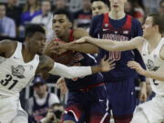 Arizona&#039;s Allonzo Trier, center, competes for the ball with Oregon&#039;s Dylan Ennis, left, and Casey Benson during the first half of an NCAA college basketball game for the championship of the Pac-12 men&#039;s tournament Saturday, March 11, 2017, in Las Vegas.