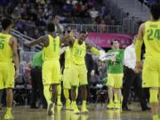 Oregon's Dylan Ennis (31) and Jordan Bell (1) celebrate after a play against California during the second half of an NCAA college basketball game in the semifinals of the Pac-12 men's tournament Friday, March 10, 2017, in Las Vegas. Oregon won 73-65.