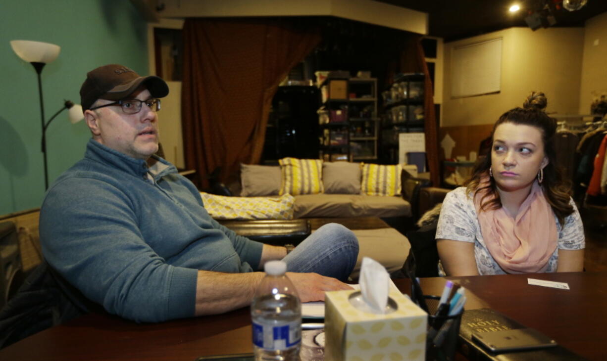 Jessica Wolfe, right, talks about her life story as she sits at The Genesis Project, a drop-in center for victims of sex trafficking in SeaTac with King County Sheriff&#039;s Deputy Andy Conner, left, who founded the center on Feb. 27. Wolfe, forced into sex trafficking at 19, now struggles to find housing and a job. (Photos by Ted S.