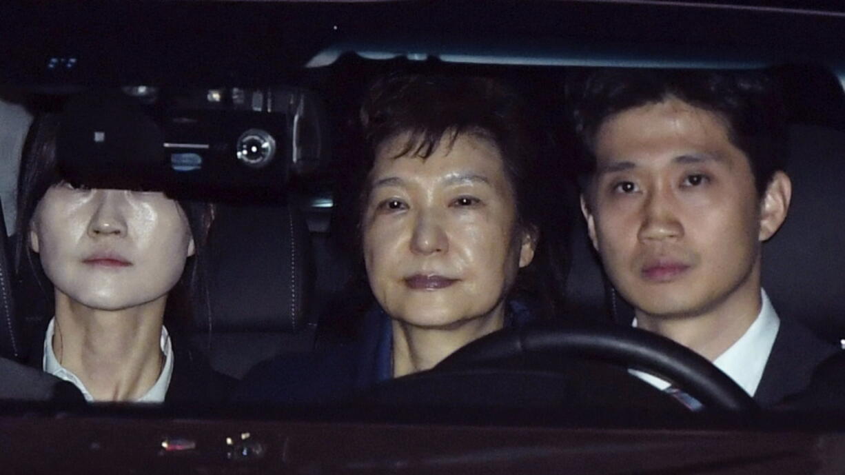 Former South Korean President Park Geun-hye, center, arrives Friday at a detention center in Uiwang, South Korea. She was jailed over corruption allegations that already ended her tumultuous four-year rule.