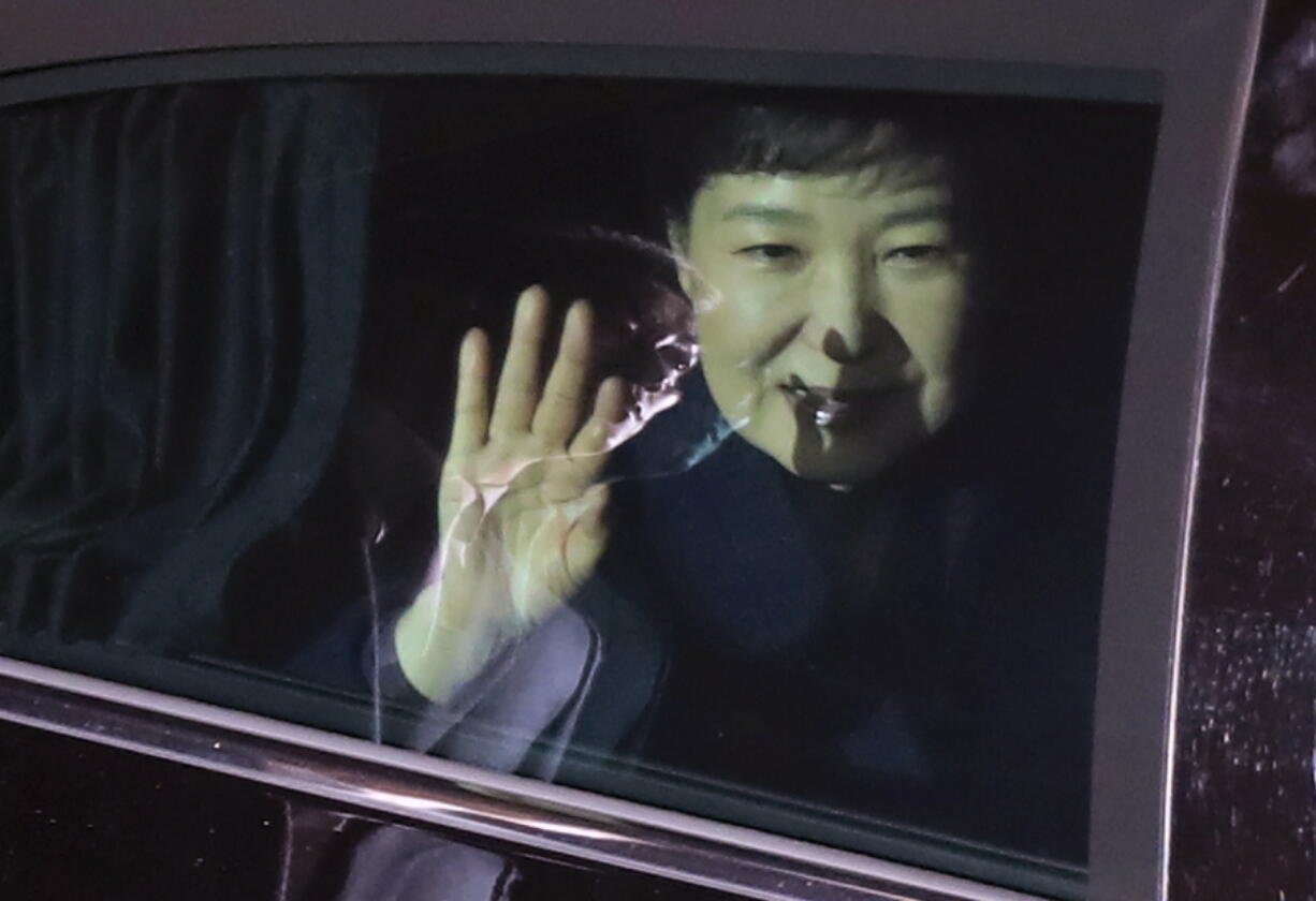 Ousted South Korean President Park Geun-hye waves to her supporters from her vehicle upon her arrival Sunday at her private home in Seoul, South Korea.