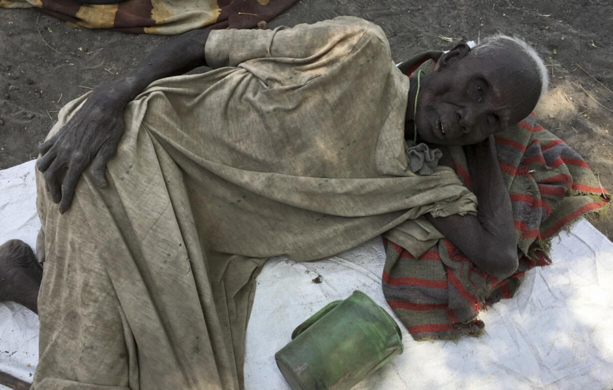 Juang Gai Vol, 87, who hadn&#039;t eaten for three days, lies down at a food distribution site March 1 in Padeah, South Sudan. South Sudanese who fled famine and fighting emerged after months in hiding to receive food aid being distributed by the World Food Program.