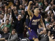 Phoenix Suns guard Devin Booker gestures after he scored a basket, as fans cheer him at TD Garden in the fourth quarter of the Suns&#039; 130-120 loss to Boston.