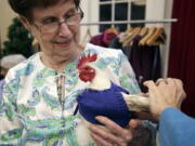 Nancy Kearns, a resident of Fuller Village retirement home, holds Prince Peep.