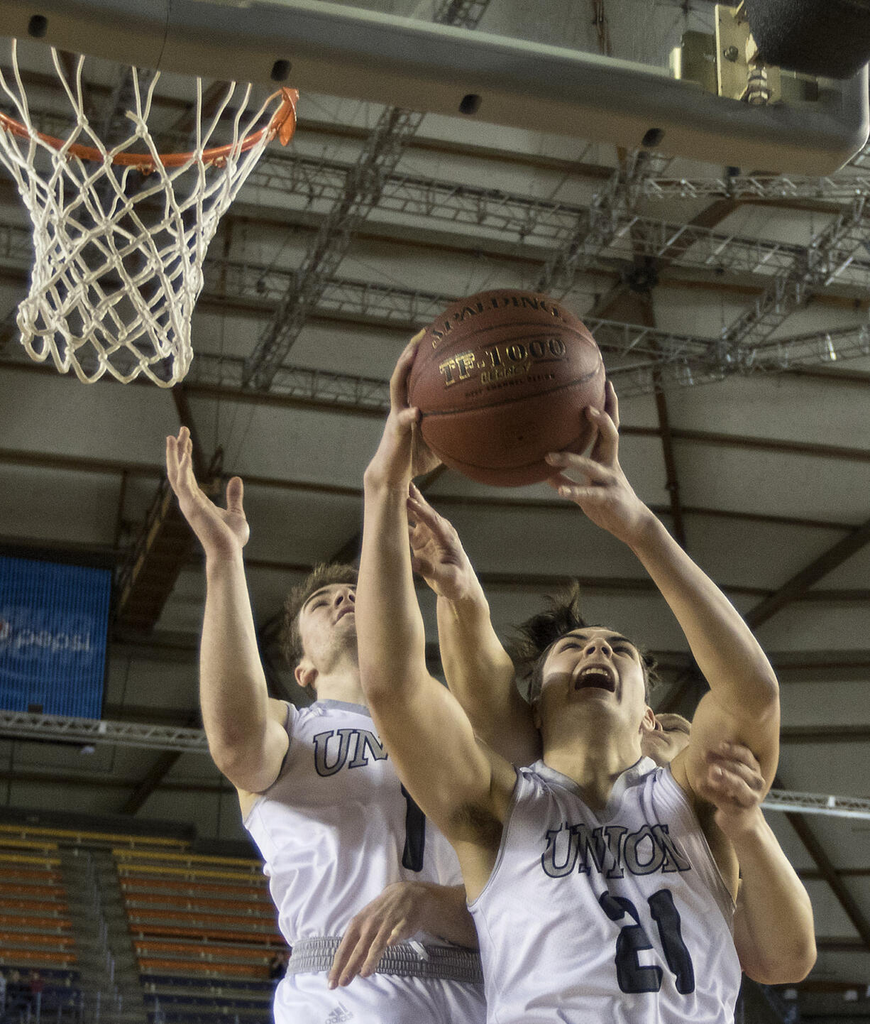 Union's Austin Lewis, right, pulls in a rebound in front of  Kennedy's Trevor Hoffman Thursday, March 2, 2017, during the  quarterfinals of the 4A Boys WA State Basketball Tournament in Tacoma, Wash. Union won 73-49 to advance.