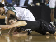 Union's Austin Lewis, below, fights for a loose ball with Kentwood's Darius Lubom Saturday, March 4, 2017, during the 4A Boys State Basketball Tournament Championship game in Tacoma, Wash. Union lost 81-61 to take seconnd place.