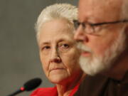 Cardinal Sean O&#039;Malley, the archbishop of Boston, right, and Marie Collins attend a press conference at the Vatican. Collins, an Irish woman who was sexually abused by clergy, has quit in frustration her post on a Vatican commission advising Pope Francis about how to fight abuse of minors, Wednesday, March 1, 2017.