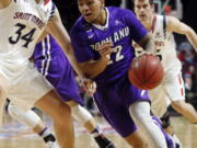 Portland&#039;s Jazz Johnson (22) drives to the basket as Saint Mary&#039;s Jock Landale defends during the first half of a West Coast Conference tournament NCAA college basketball game Saturday, March 4, 2017, in Las Vegas.