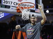 Gonzaga&#039;s Nigel Williams-Goss cuts down a piece of the net after defeating Saint Mary&#039;s in an NCAA college basketball game during the championship of the West Coast Conference tournament, Tuesday, March 7, 2017, in Las Vegas. Gonzaga won 74-56.