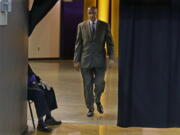 FILE - In this Jan. 18, 2017 file photo, Washington coach Lorenzo Romar walks past a curtain as he heads to the court for the team&#039;s NCAA college basketball game against Colorado in Seattle. Washington announced Wednesday, March 15, 2017, that Romar had been fired after 15 seasons at the school. (AP Photo/Ted S.