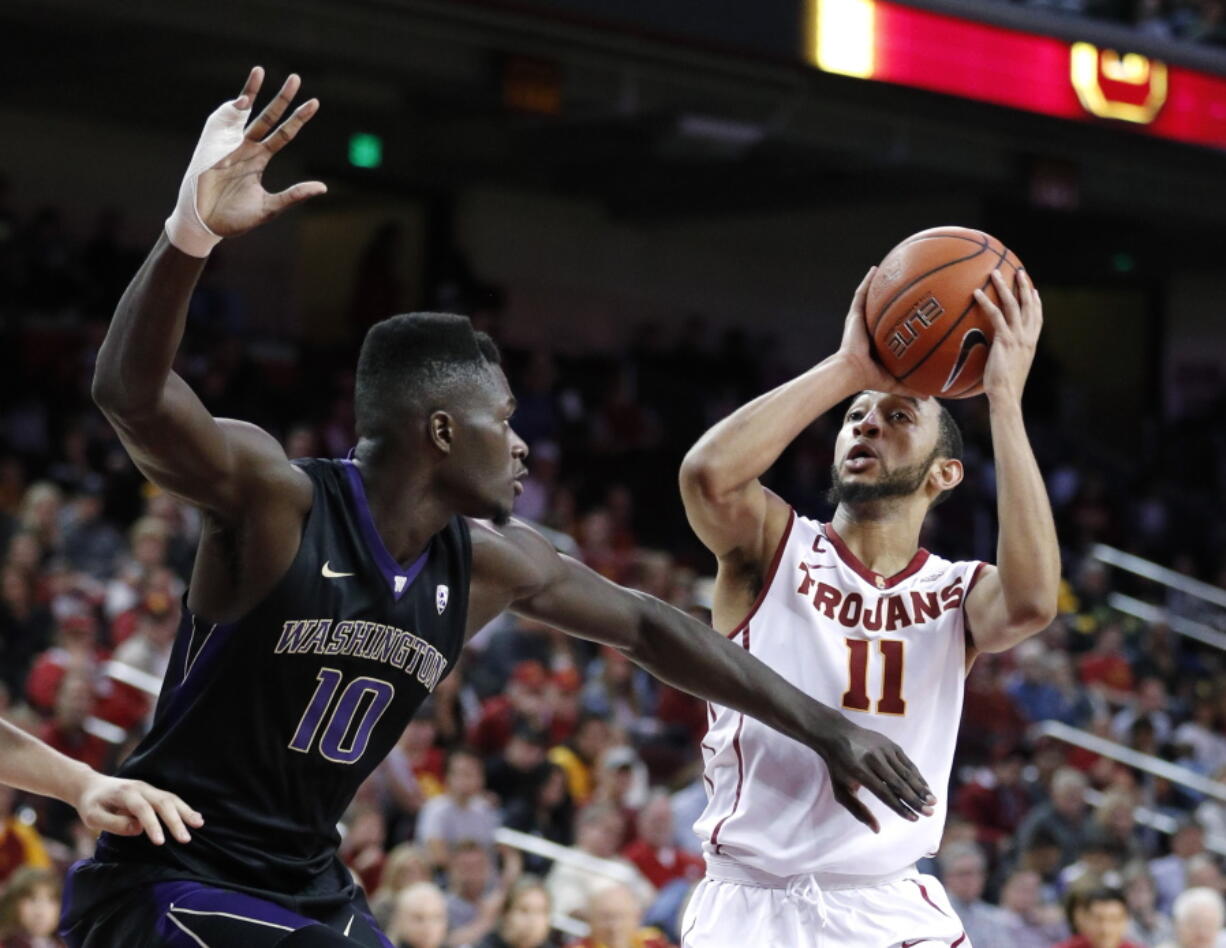 Southern California&#039;s Jordan McLaughlin, right, shoots as Washington&#039;s Malik Dime defends during the second half of an NCAA college basketball game, Saturday, March 4, 2017, in Los Angeles. (AP Photo/Jae C.