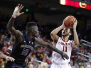 Southern California&#039;s Jordan McLaughlin, right, shoots as Washington&#039;s Malik Dime defends during the second half of an NCAA college basketball game, Saturday, March 4, 2017, in Los Angeles. (AP Photo/Jae C.