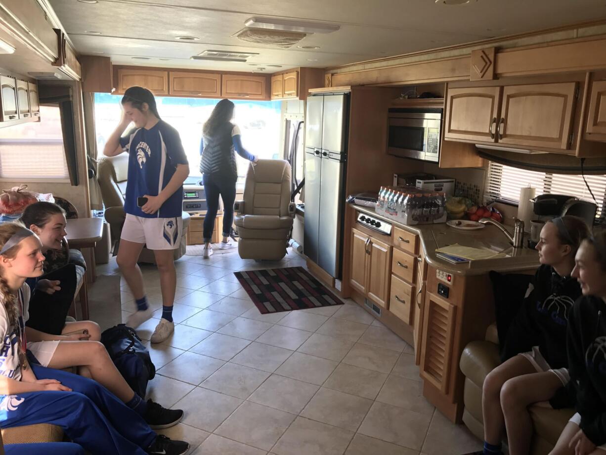 Taylor Mills (left) and the La Center Wildcats celebrate their 48-46 victory over Columbia (Burbank) inside teammate Taylor Stephens' family's RV outside the Yakima Valley SunDome on Wednesday. Mills hit an 18-foot buzzer beater and finished with eight points.