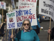 Geri Baer waves a sign reading &quot;Trumpcare Kills Seniors&quot; at a recent rally in Clark County. Several different Indivisible chapters coordinated their efforts and spread across Clark County, waving signs to show support for the Affordable Care Act.