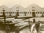 Troops stack slabs of spruce as they&#039;re being unloaded from a rail car. The wood was favored by World War I aircraft builders.