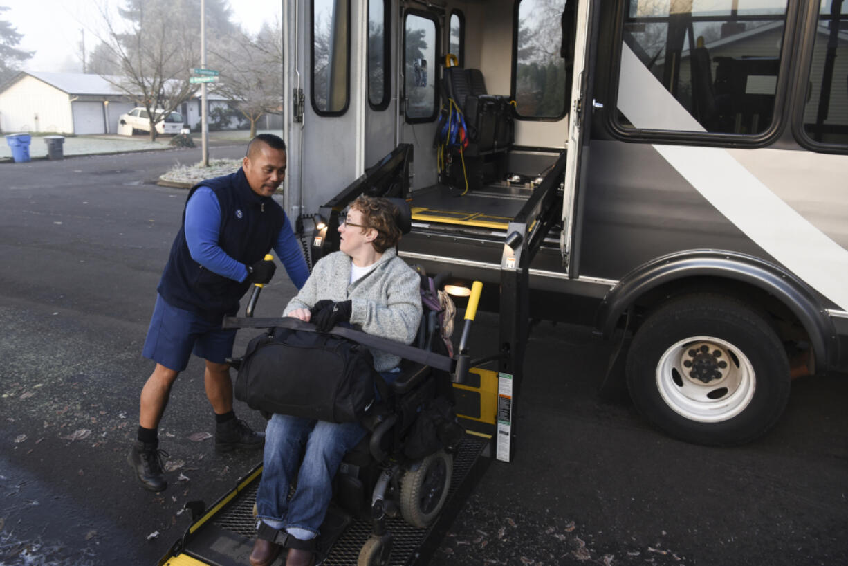 C-Van driver Jaime Somosot helps customer Kristine Graham in December.