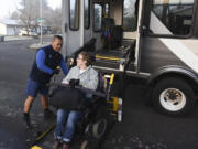 C-Van driver Jaime Somosot helps customer Kristine Graham in December.