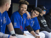 Clark College outfielder Charles Clark Jr. (second from left) and shortstop/second baseman Reinaldo Gonzalez have formed an otherwise unlikely friendship through the language of Spanish. (Randy L.