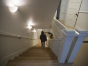 Public affairs officer Sue Ripp descends a staircase at Fort Vancouver National Historic Site after the Gifford Pinchot National Forest moved into the Vancouver Barracks building in January.