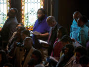 Descendants of the 272 enslaved sold by Georgetown University in 1838, participate Tuesday in a Liturgy of Remembrance, Contrition and Hope on the campus of Georgetown University in Washington.