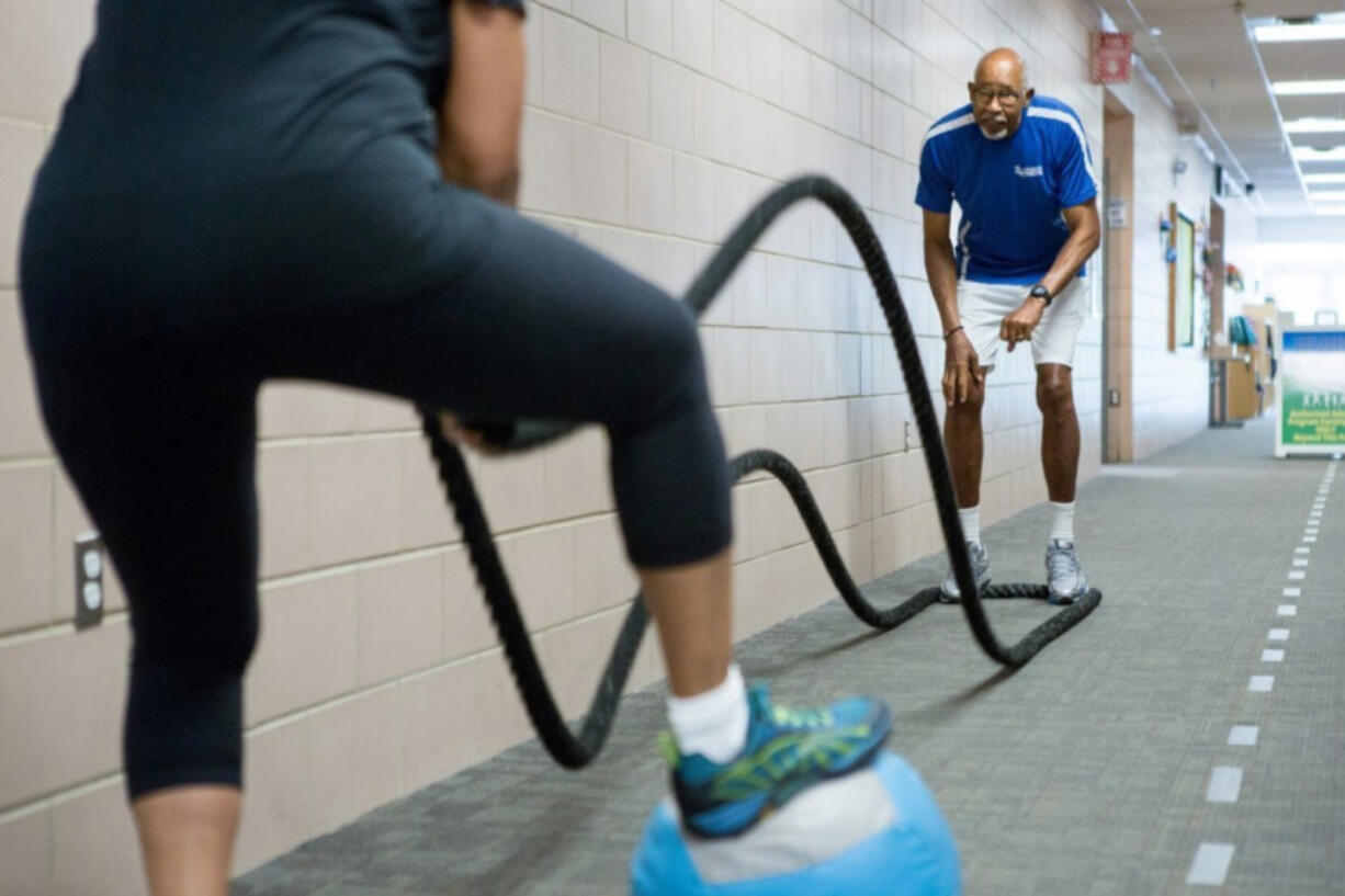 Dawson works with client Rachel Hines at the Chinn Aquatic and Fitness center in Woodbridge, Va. Dawson, who just turned 80, tailors each workout session to the particular needs of his mostly senior clientele.